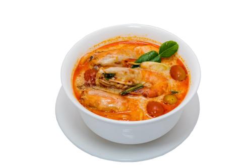 a bowl of seafood soup on a white background at New Siam Palace Ville Hotel in Bangkok