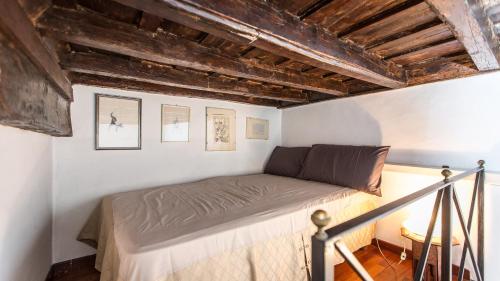 a bed in a room with wooden ceilings at Monti Flat Rental in Rome in Rome