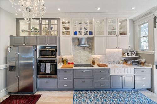 a kitchen with white cabinets and stainless steel appliances at San Francisco Retreat Just Steps from Golden Gate Park and Ocean Beach! home in San Francisco