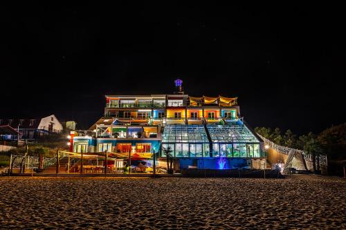 a large building is lit up at night at UnderSun Spa Hotel in Gribovka