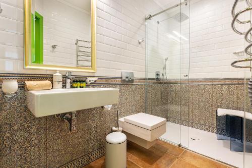 a bathroom with a sink and a toilet and a mirror at UnderSun Spa Hotel in Gribovka