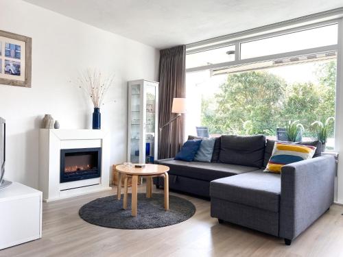 a living room with a couch and a fireplace at Vakantie appartement Westkapelle WE05 in Westkapelle