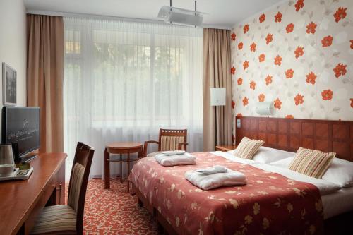 Säng eller sängar i ett rum på Spa Resort Sanssouci