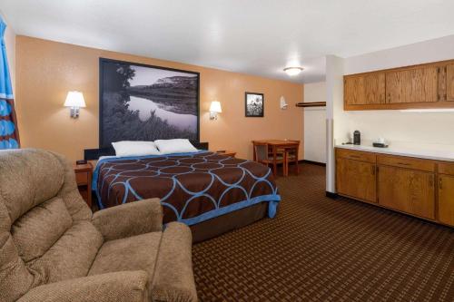 a hotel room with a bed and a kitchen at Super 8 by Wyndham Goodland in Goodland