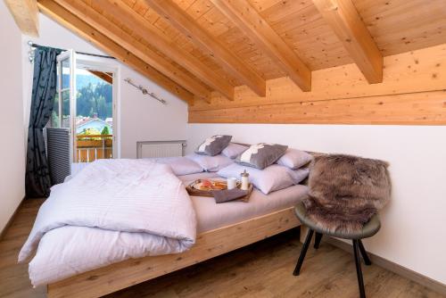 a bedroom with a bed and a chair at BergFux Ferienhaus - hochwertige Ausstattung in Sonthofen