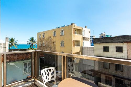 a balcony with a view of a building and the ocean at Long To Sea Again in Hualien City
