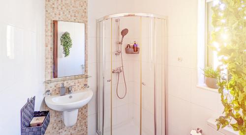 a bathroom with a shower and a sink at Holiday Hub Gozo - 3 Bedrooms in Xewkija