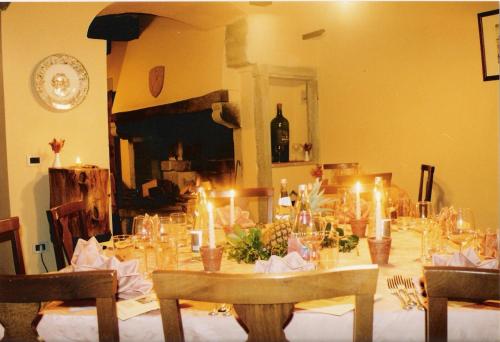 a dining room with a table with candles on it at Villa Vezza in Capolona