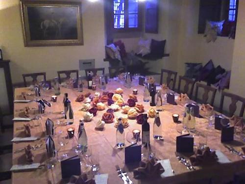 a large wooden table with many items on it at Villa Vezza in Capolona