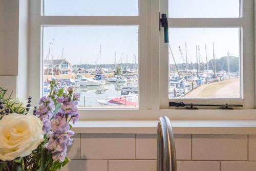 a kitchen window with a view of a marina at The Old Granary Cottage Woodbridge Air Manage Suffolk in Woodbridge