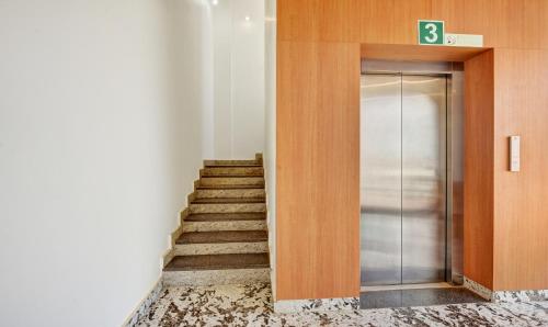 a staircase leading to a elevator in a building at Itsy Hotels Shrey'S Inn Mallandur Road in Chikmagalūr