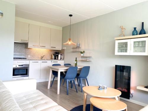 a kitchen and living room with a table and chairs at Vakantieappartement Westkapelle WE06 in Westkapelle