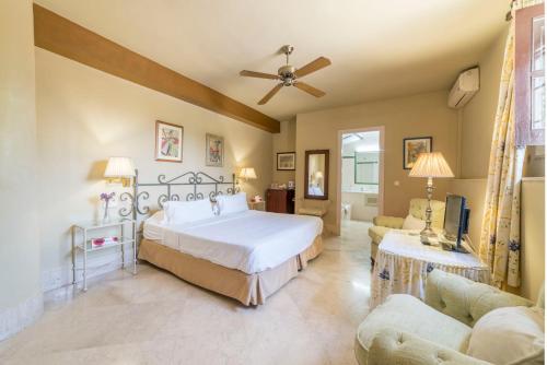 a bedroom with a large bed and a living room at Casa de los Bates in Motril