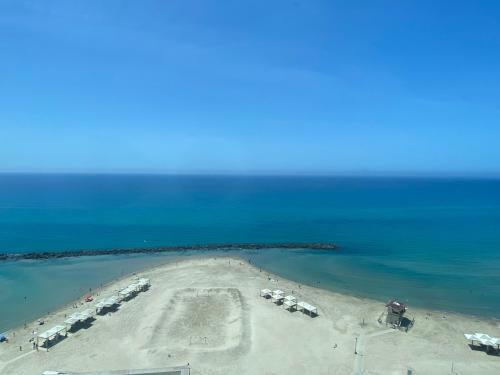 an aerial view of an island in the ocean at Almog Haifa Israel Apartments מגדלי חוף הכרמל in Haifa