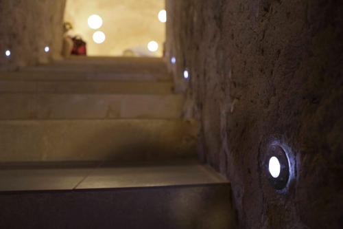 a stairway with a hole in a stone wall at Le Dodici Lune in Matera