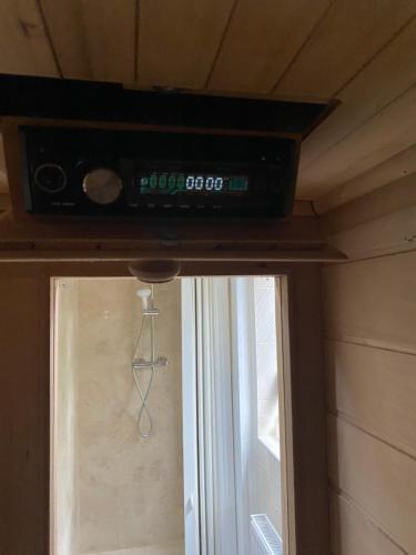 a television on top of a window in a room at Mansion 8 bedrooms in Private Gated Ave Huge garden Hot tub FREE SAUNA up to 23 in Luton