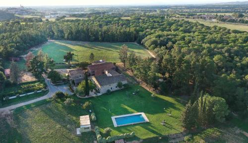 an aerial view of a house with a swimming pool at Mas Rauric in Llagostera