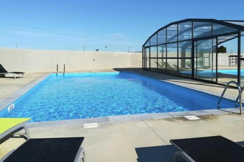 a swimming pool in a building with a glass house at Chalet in Pomérols near Mediterranean Beaches in Pomérols