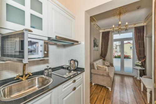 a kitchen with a sink and a microwave at IQ Hotel in Istanbul