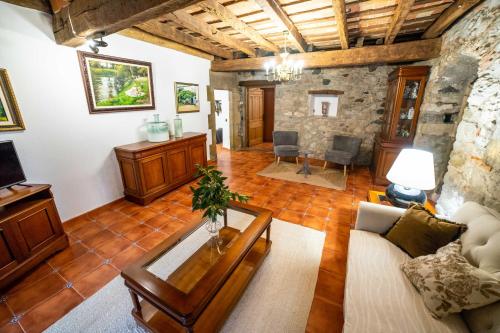 a living room with a couch and a table at Mas Vedruna in Les Planes d'Hostoles
