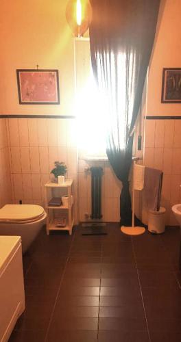 a bathroom with a white toilet and a window at B&B Stanze Lussuose in Aversa