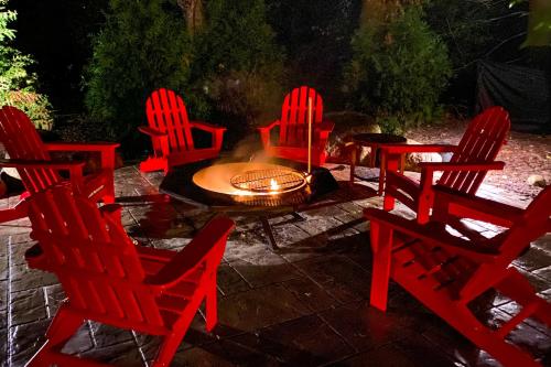 a group of red chairs around a fire pit at Friendly Farms in Lakeside