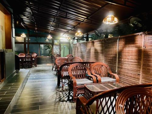 a restaurant with wooden chairs and tables and lights at Samskara & Samsara in Lansdowne