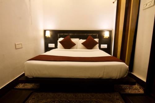 a bedroom with a large bed with pillows at Samskara & Samsara in Lansdowne