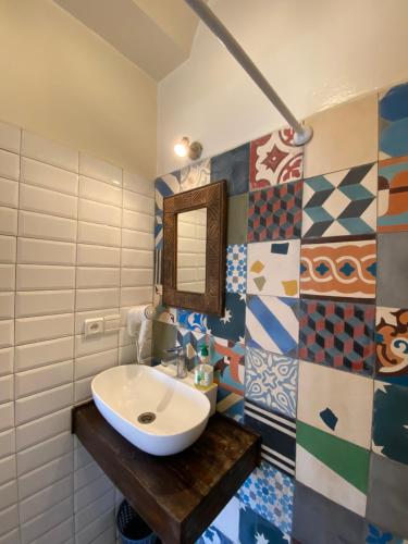 a bathroom with a sink and a mirror at Riad Inna & Watersports Center in Essaouira