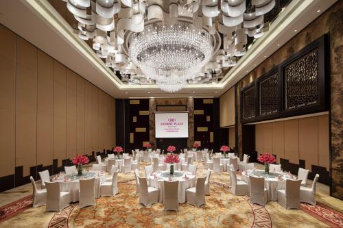 a banquet hall with tables and chairs and a chandelier at Crowne Plaza Guangzhou Huadu by IHG - Free Shuttle bus between hotel to Exhibition Center During Canton Fair in Guangzhou