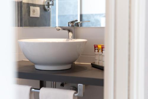a white bowl sink on a counter in a bathroom at Hotel Monte Rosa in Chiavari