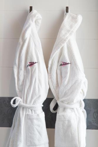 two white towels hanging on a rack in a bathroom at Hotel Monte Rosa in Chiavari