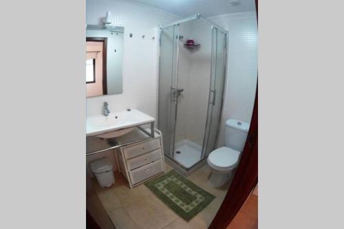 a bathroom with a shower and a sink and a toilet at CasaMandy CotilloMar in Cotillo