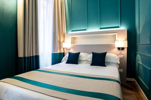 a bedroom with a large bed with blue cabinets at Hotel Monte Rosa in Chiavari