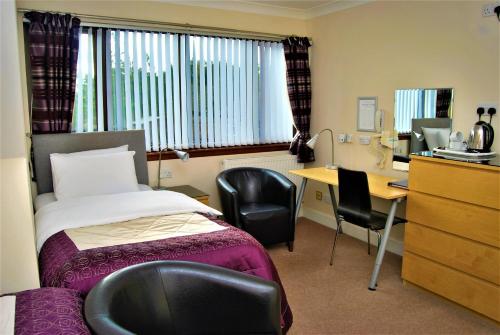 A bed or beds in a room at The Old Schoolhouse Hotel