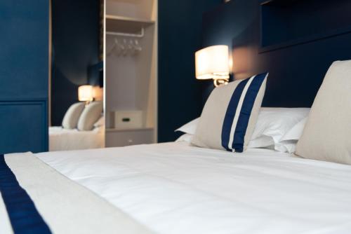 a bedroom with a bed with blue walls and a mirror at Hotel Monte Rosa in Chiavari