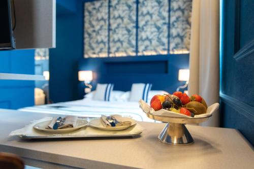 a bowl of fruit on a table in a hotel room at Hotel Monte Rosa in Chiavari