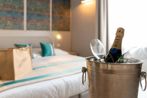 a metal bucket filled with wine bottles and wine glasses at Hotel Monte Rosa in Chiavari
