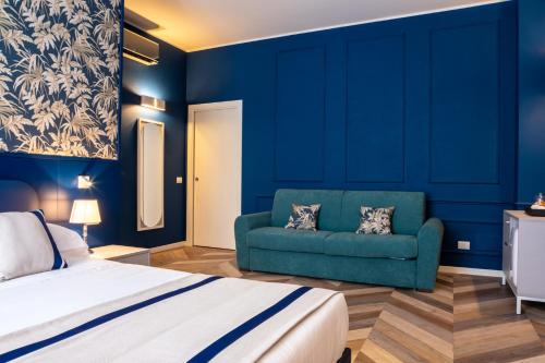 a bedroom with a bed and a green couch at Hotel Monte Rosa in Chiavari