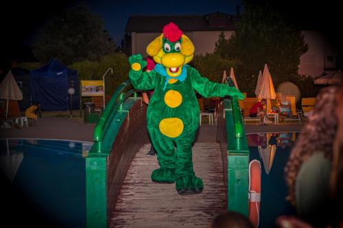 a person dressed as a clown walking down a slide at Parc Hotel in Peschiera del Garda