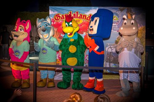 a group of mascots standing in front of a sign at Parc Hotel in Peschiera del Garda
