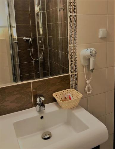 a bathroom sink with a shower and a phone at Villa Riccona in Bronisze
