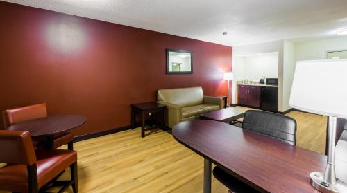 a living room filled with furniture and a large window at Red Roof Inn PLUS+ South Deerfield - Amherst in South Deerfield
