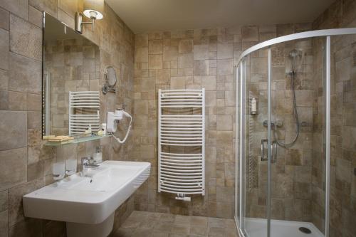 a bathroom with a sink and a shower at Resort Sobotín in Sobotín