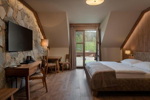 Postel nebo postele na pokoji v ubytování Resort Sobotín