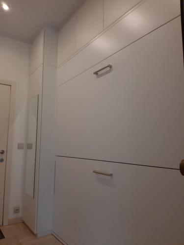 a white closet with two drawers and a mirror at Den oever 6 005 in Nieuwpoort