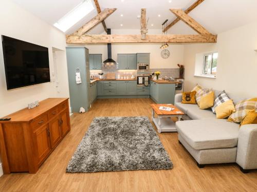 a living room with a couch and a table at Y Felin The Granary in Caernarfon