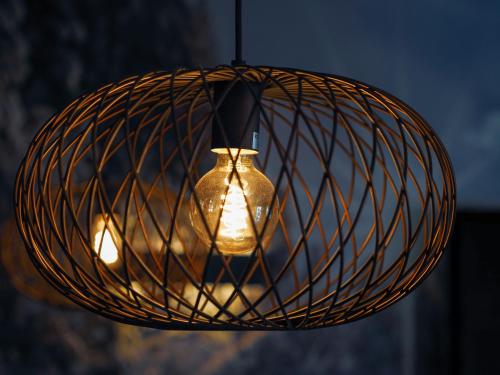 a light hanging from a wire basket at Design Hotel ALPENLIEBE - - - - Boutique-Flair - - - - in Inzell