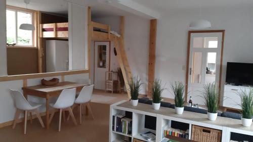 a living room with a table and chairs and a dining room at Ferienwohnung Alte Dorfschule in Witzenhausen