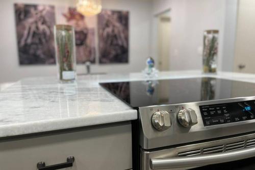 a kitchen with a stove and a counter top at ATL XPLOR (8mins to Airport/10mins to midtown) in Atlanta